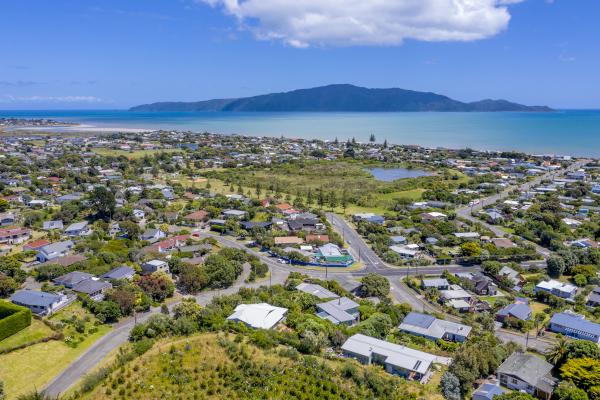 a panoramic shot of a coastal town under blue skies