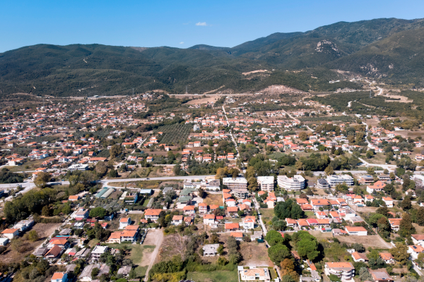 a panoramic shot of a coastal town under blue skies